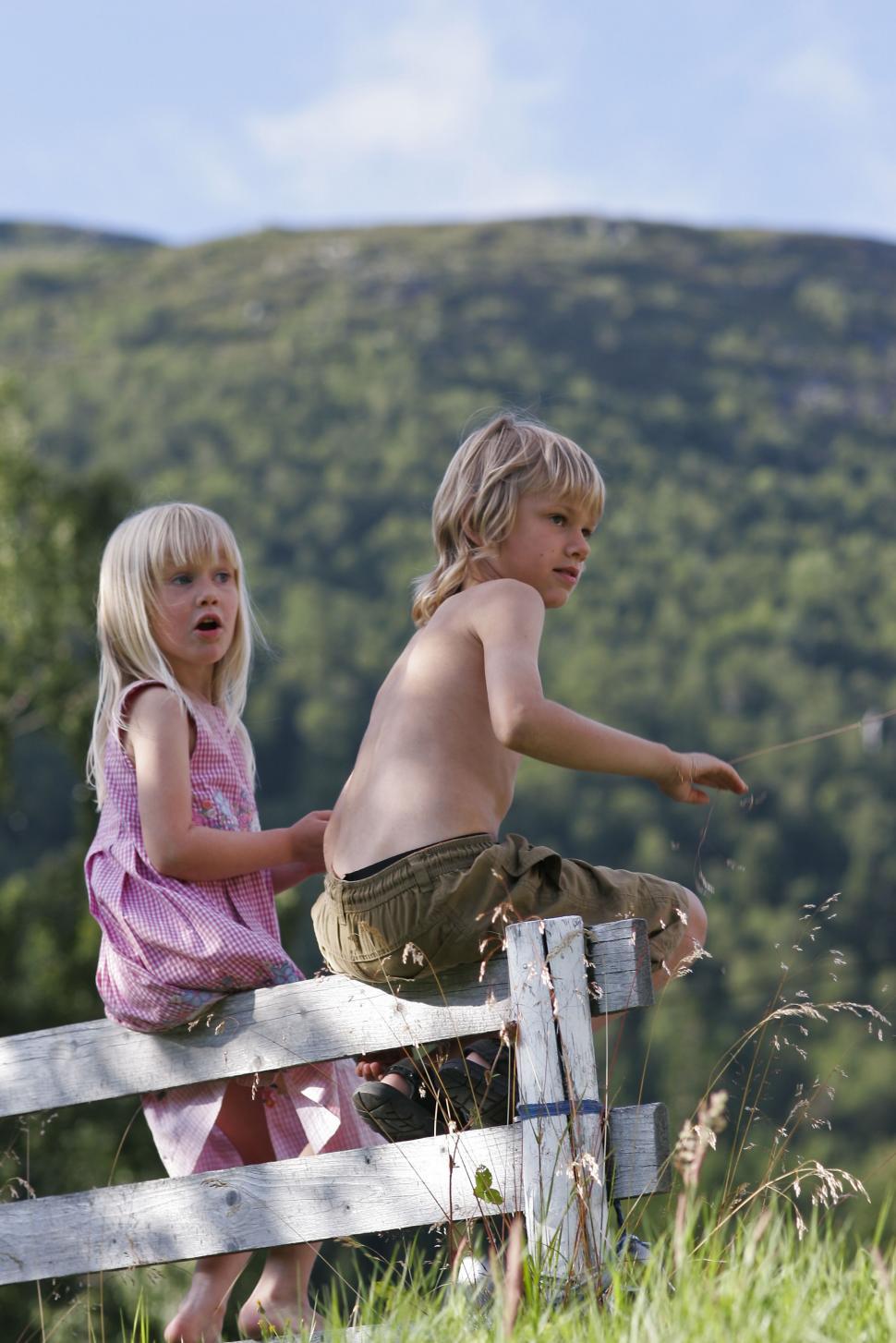Free Image of Kids Standing on Top of Wooden Fence 
