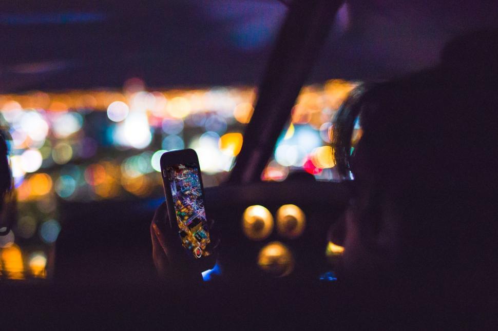 Free Image of Person Holding Cell Phone in Car 