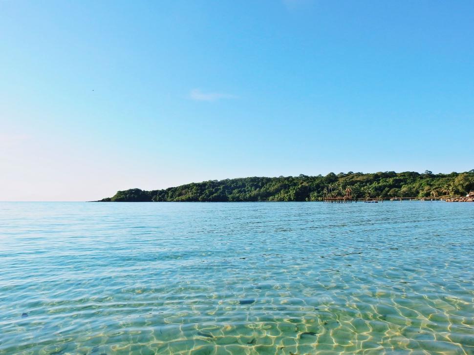 Free Image of A Body of Water With a Small Island in the Distance 