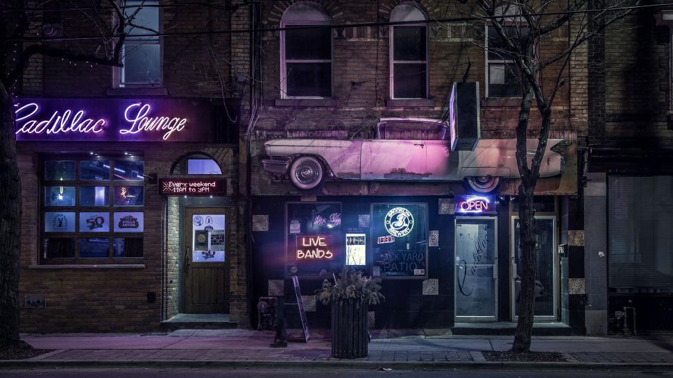 Free Image of Neon Sign Illuminates Front of Urban Building 