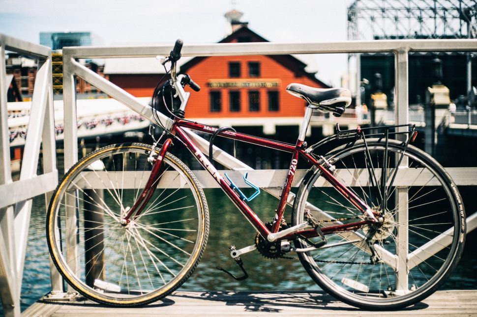 Free Image of Bike Parked on Bridge Over Body of Water 