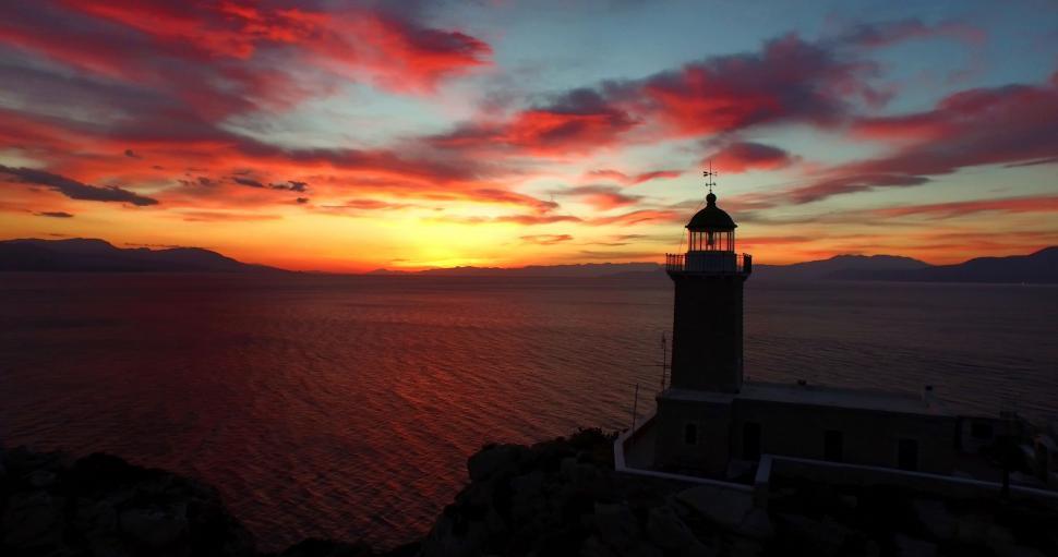Free Image of Lighthouse on Cliff Overlooking Ocean 