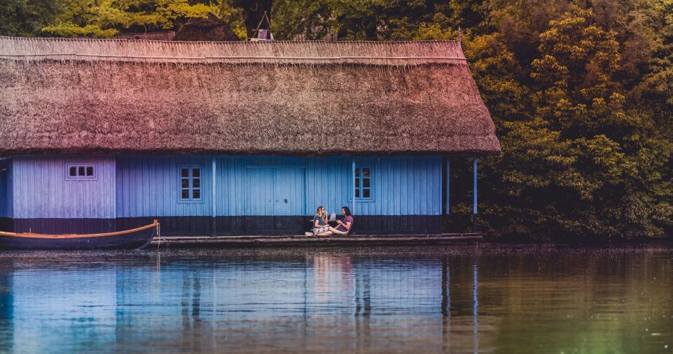 Free Image of Two People Sitting on a Boat in a Body of Water 
