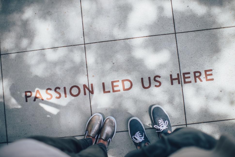 Free Image of Feet Standing by Passion Led Us Here Sign 
