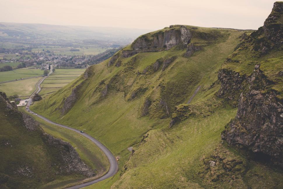 Free Image of Winding Road Through Lush Green Hillside 
