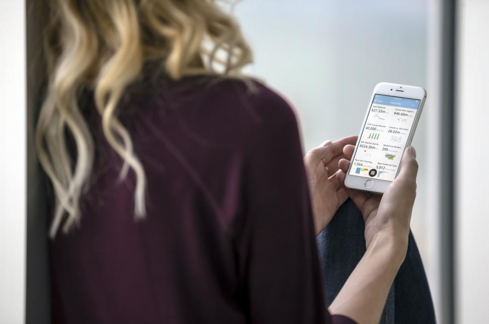 Free Image of Woman Looking at Cell Phone in Mirror 