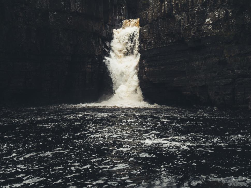 Free Image of Majestic Waterfall Cascading Down Rocks 