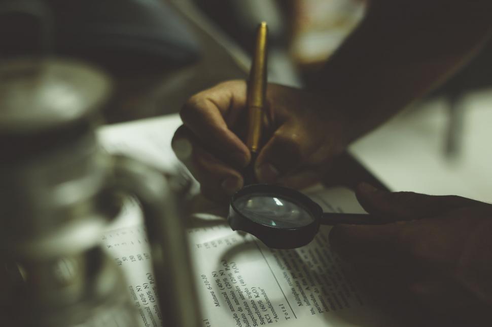 Free Image of Person Holding Pair of Scissors Over Piece of Paper 