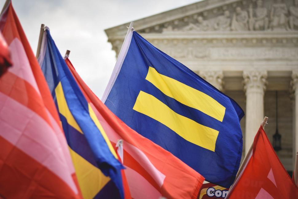 Free Image of Flags in Front of Building 