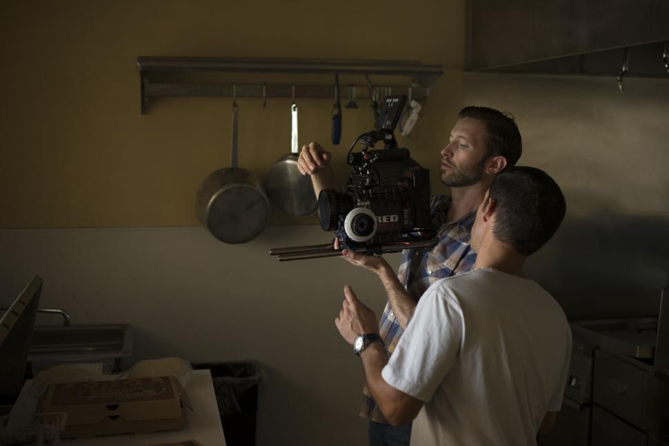 Free Image of Man Holding Camera In Kitchen 