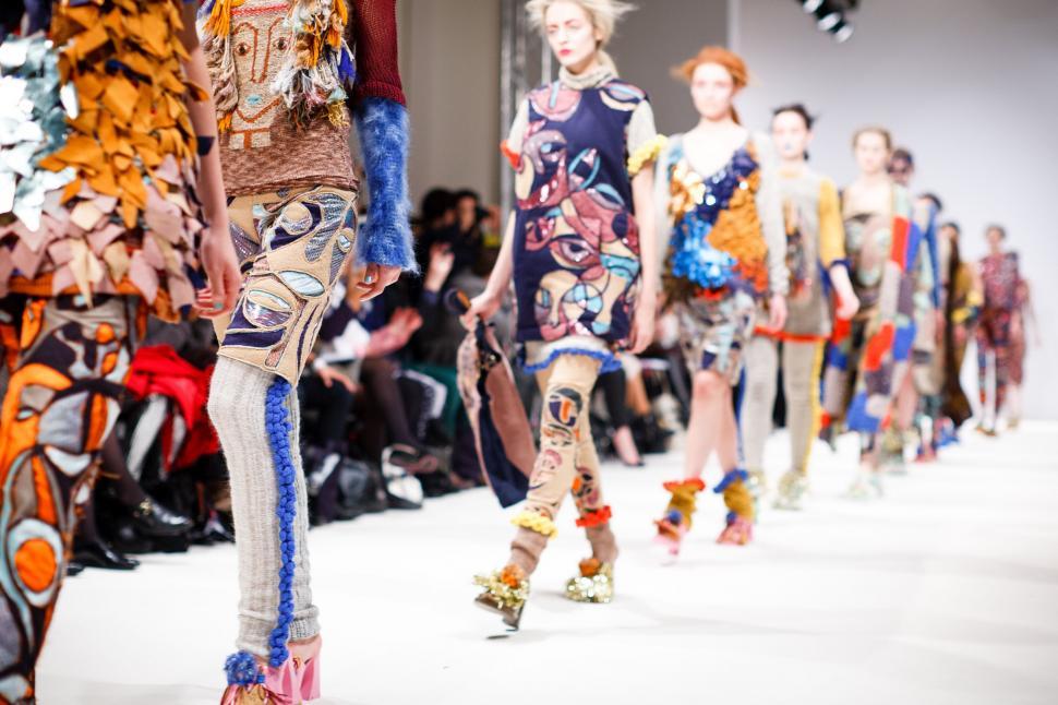 Free Image of Group of People Walking Down a Runway 