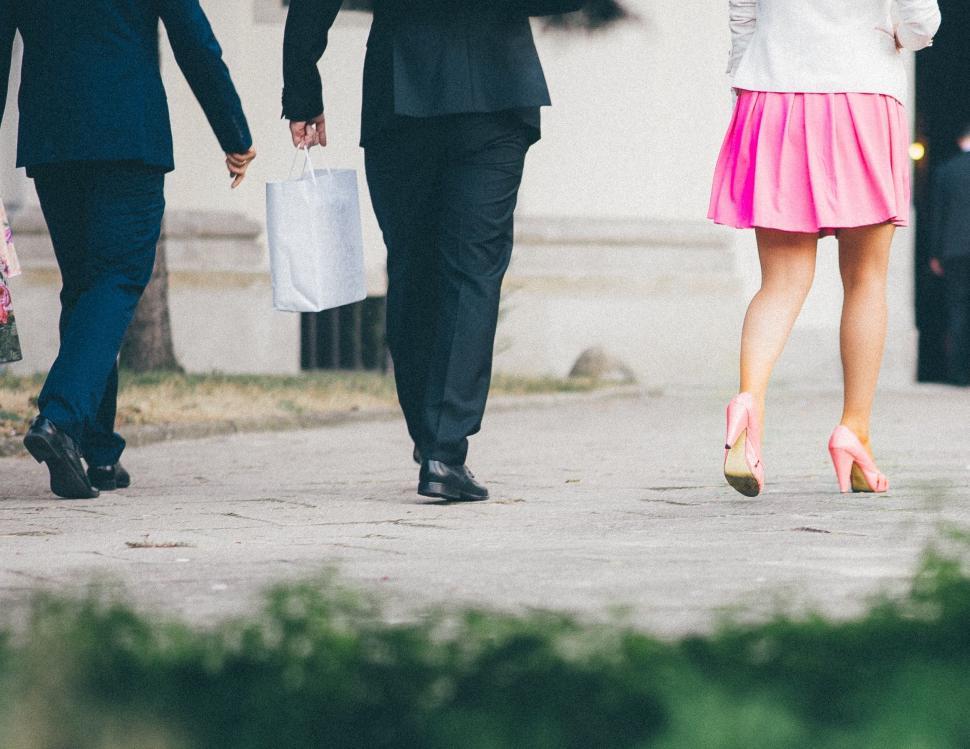 Free Image of Group of People Walking Down a Sidewalk 