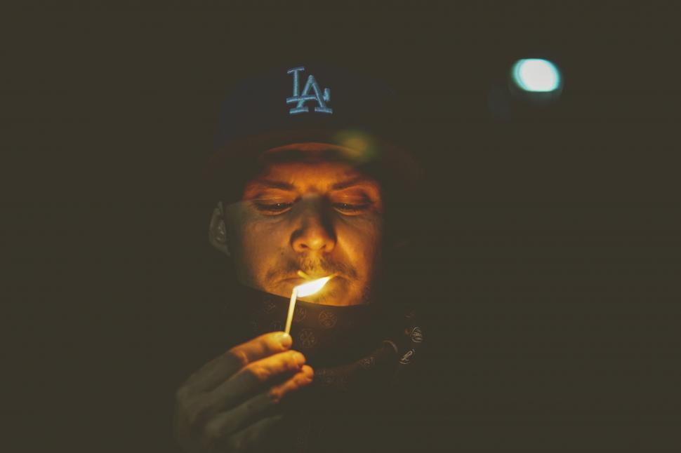 Free Image of Man Holding Lit Match 