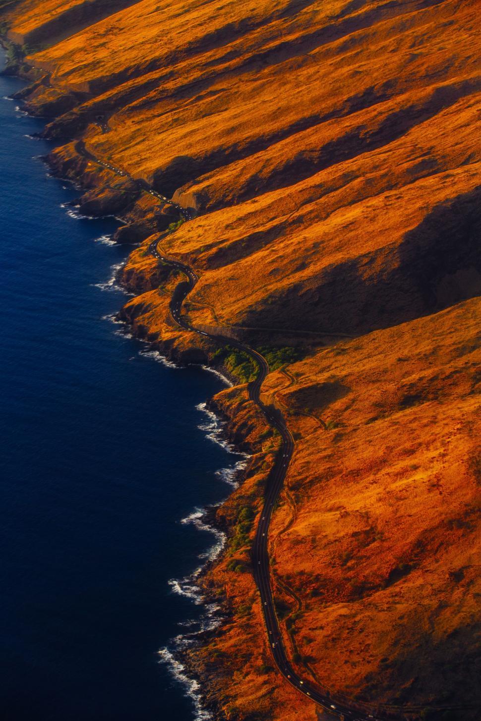 Free Image of Large Body of Water Surrounded by Brown Grass 