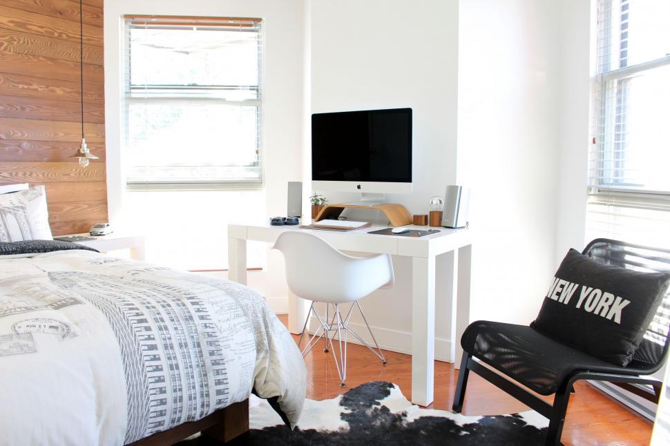 Free Image of Modern Bedroom With Bed, Desk, and Chair 