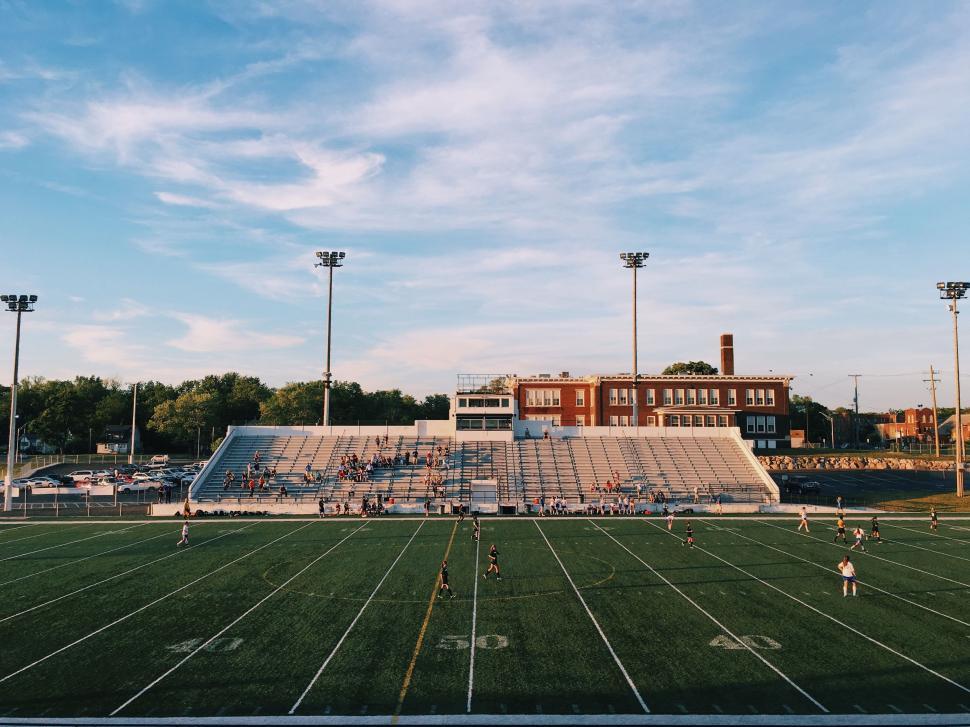 Free Image of Football Field With Stadium in the Background 