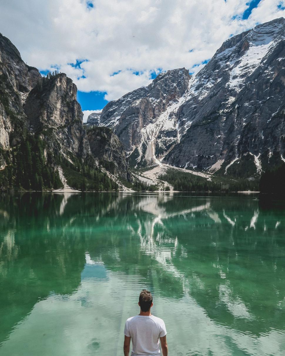 Free Image of Man Standing in Front of Mountain Lake 