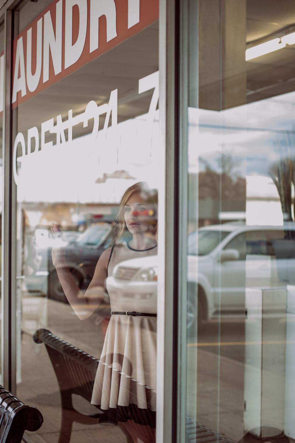 Free Image of Woman Sitting on Bench by Window 