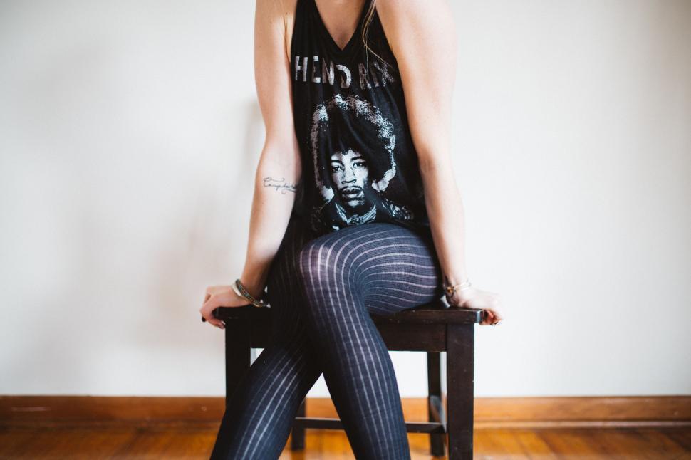 Free Image of Woman Sitting on Top of a Wooden Chair 