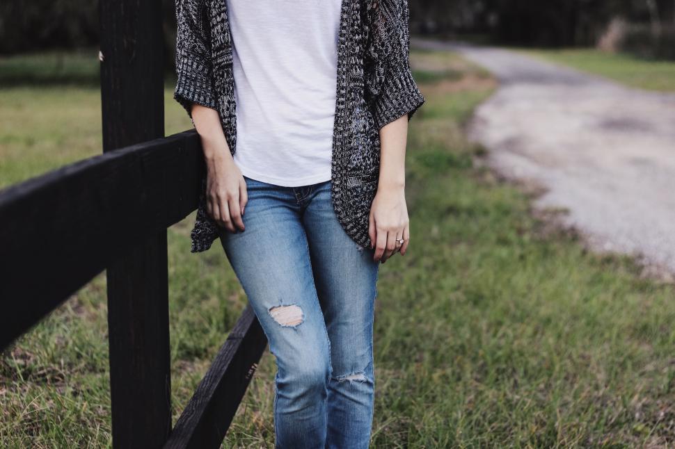 Free Image of Woman Standing Next to Fence in Field 