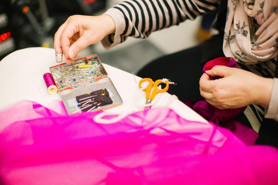 Free Image of Woman Cutting Fabric With Scissors 