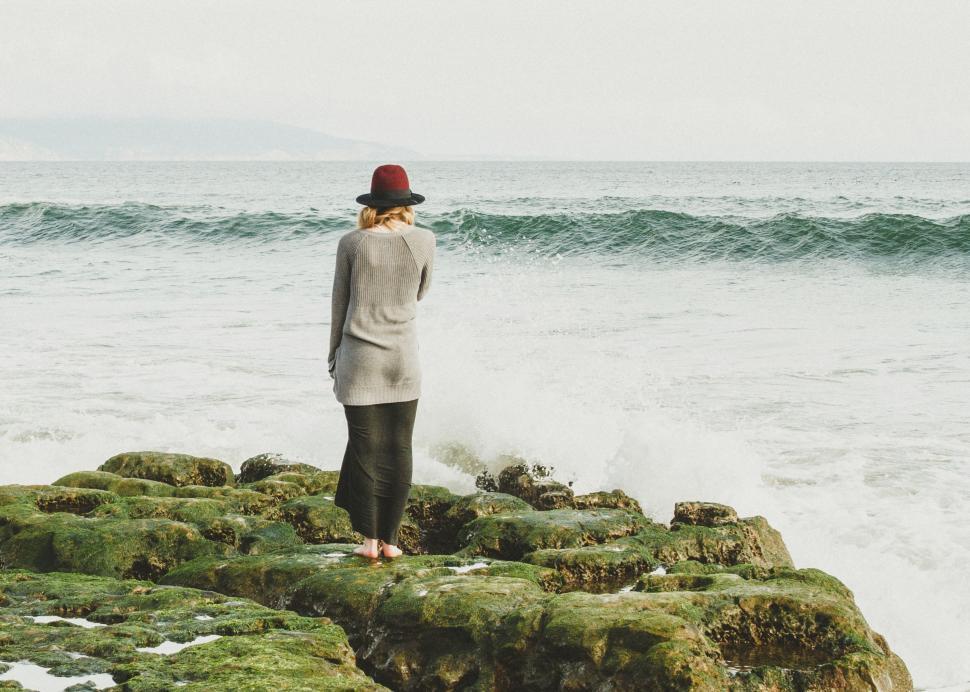 Free Image of Person Standing on Rock Near Ocean 