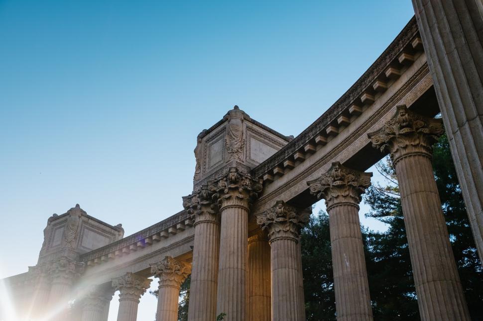 Free Image of Sun Shines Through Columns of Building 