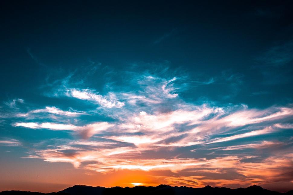 Free Image of Sun Setting Over Mountain Range 