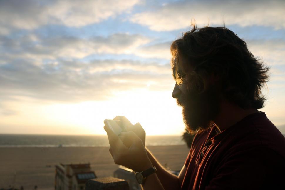 Free Image of Man Eating Hot Dog With a Beard 