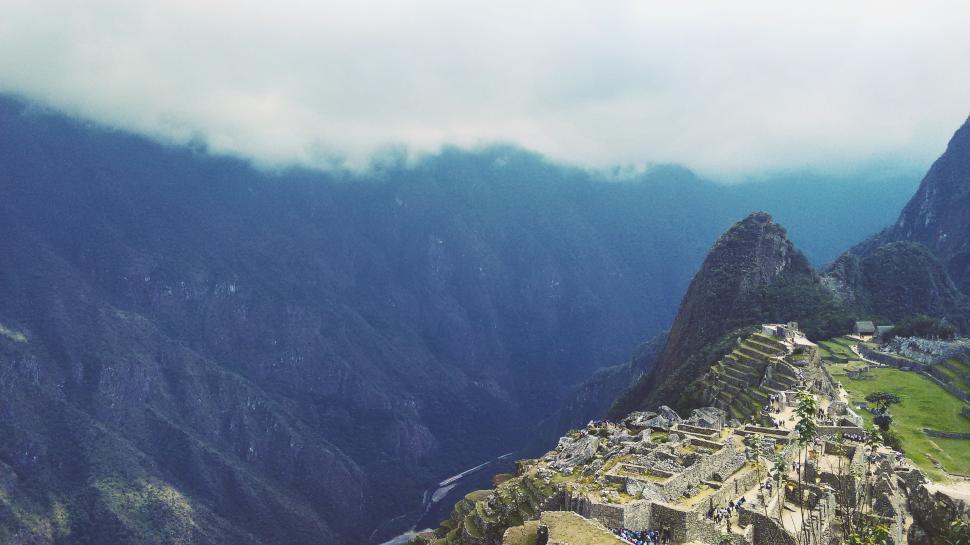 Free Image of Mountain Range With Building in Foreground 