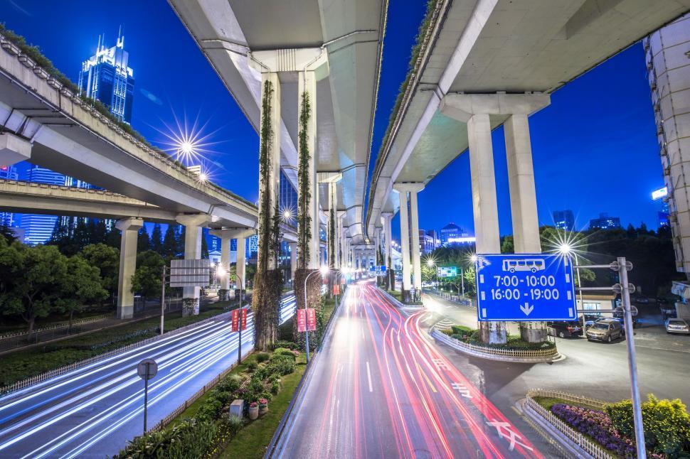 Free Image of Busy City Street With Heavy Traffic Under Bridge 