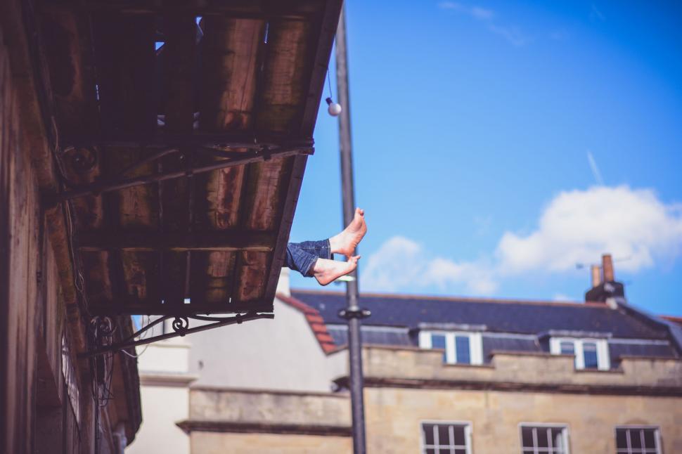 Free Image of Person Hanging Upside Down From Building 