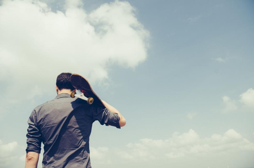 Free Image of Man Standing in Front of a Cloud Filled Sky 