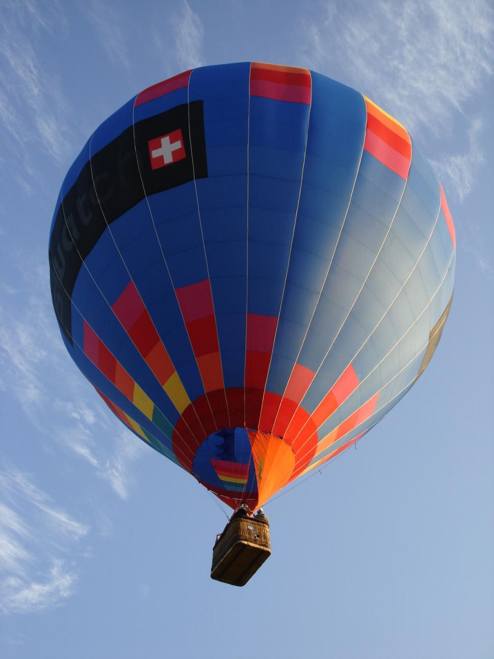 Free Image of Colorful Hot Air Balloon Flying Through Blue Sky 