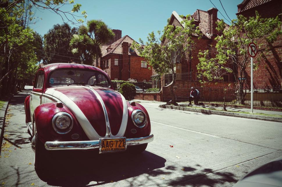 Free Image of Red and White Car Parked on Side of Road 
