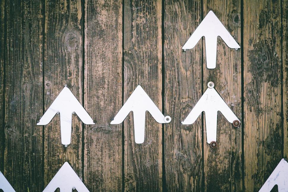 Free Image of Group of White Arrows Pointing in Different Directions 