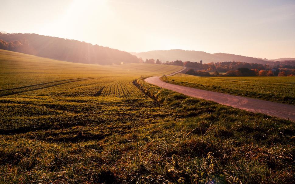 Free Image of Dirt Road Cutting Through Grassy Field 