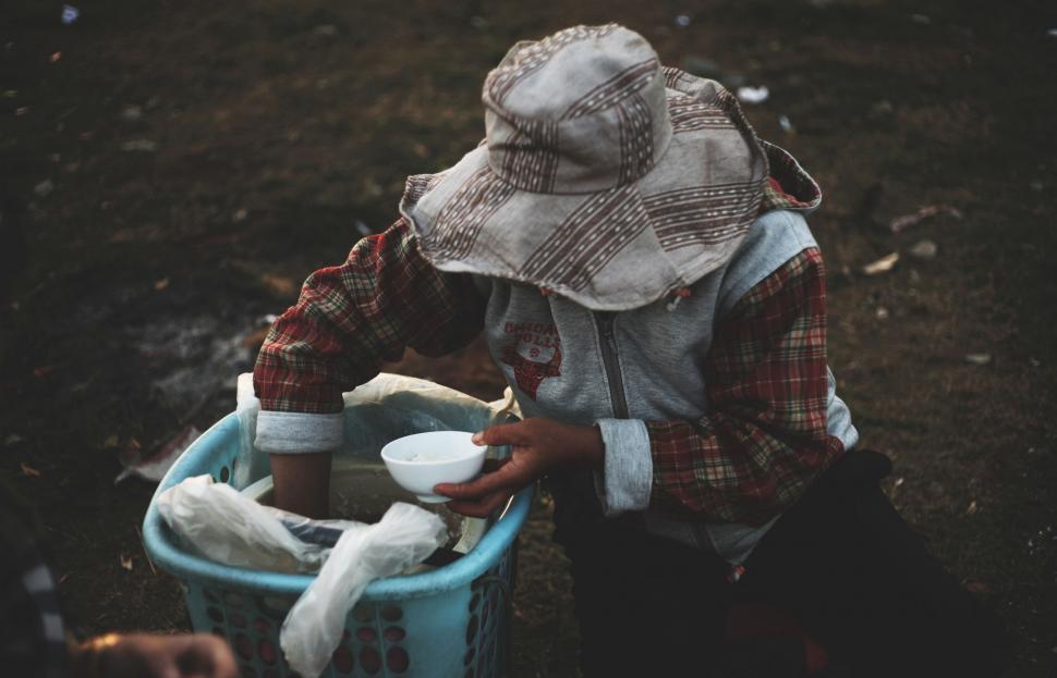 Free Image of Person Sitting in Bucket With Object 