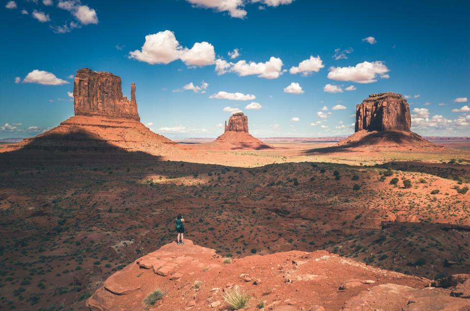 Free Image of Person Standing on Top of Rock Formation 
