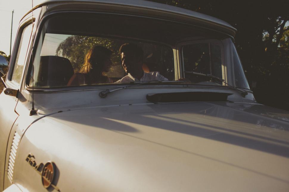 Free Image of Man Driving Vintage Car Down Street 