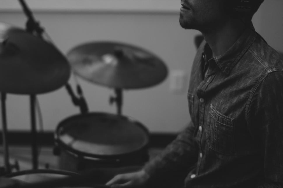 Free Image of Man Sitting in Front of Drum Set 