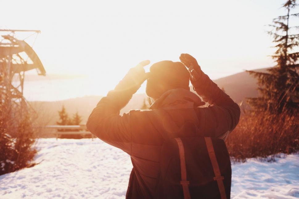 Free Image of Person Standing in Snow, Looking at Ski Lift 