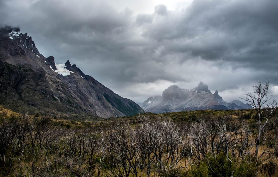 Free Image of Snow-Covered Mountains Blanketed in Clouds 