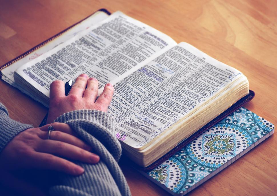 Free Image of Person Reading Book at Table 