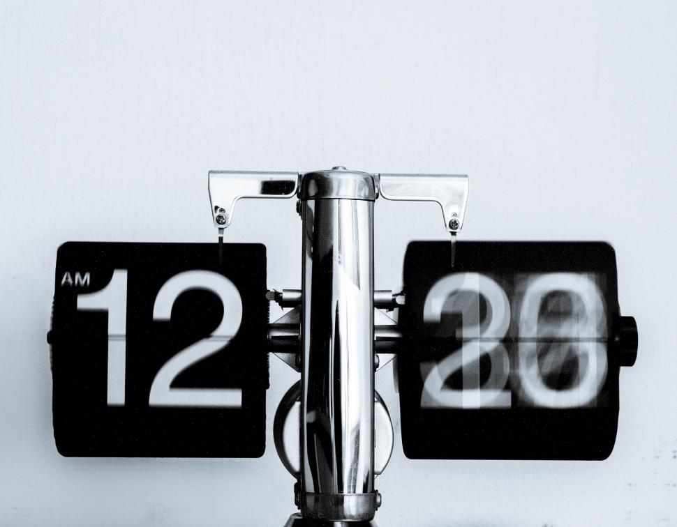 Free Image of Two Black and White Clocks on a Wall 
