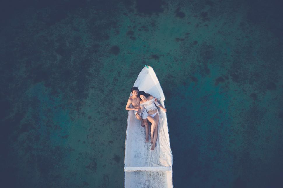 Free Image of Couple Riding on the Back of Boat 