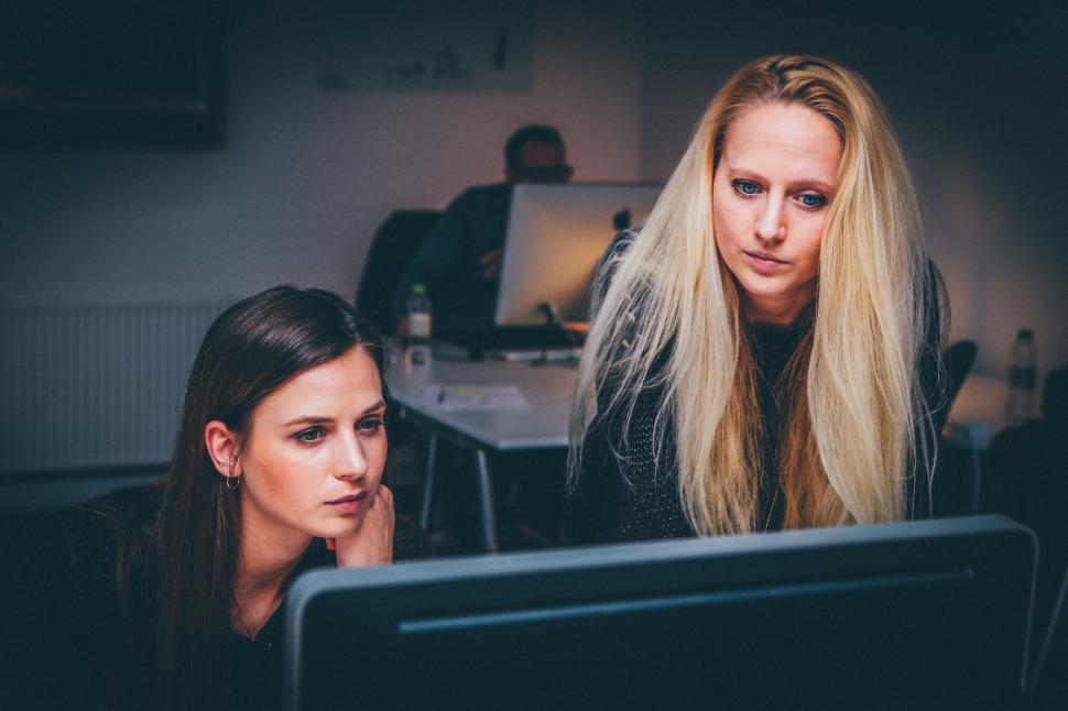 Free Image of Two Women Looking at Computer Screen 
