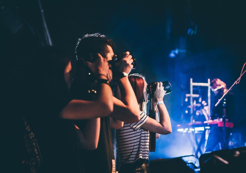 Free Image of Group of People Standing on Top of a Stage 