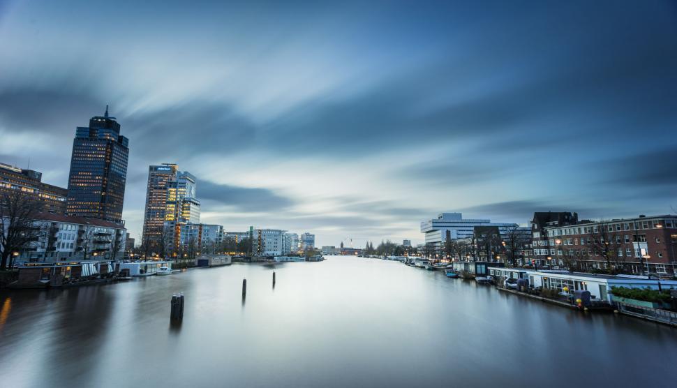Free Image of River Running Through City Beside Tall Buildings 