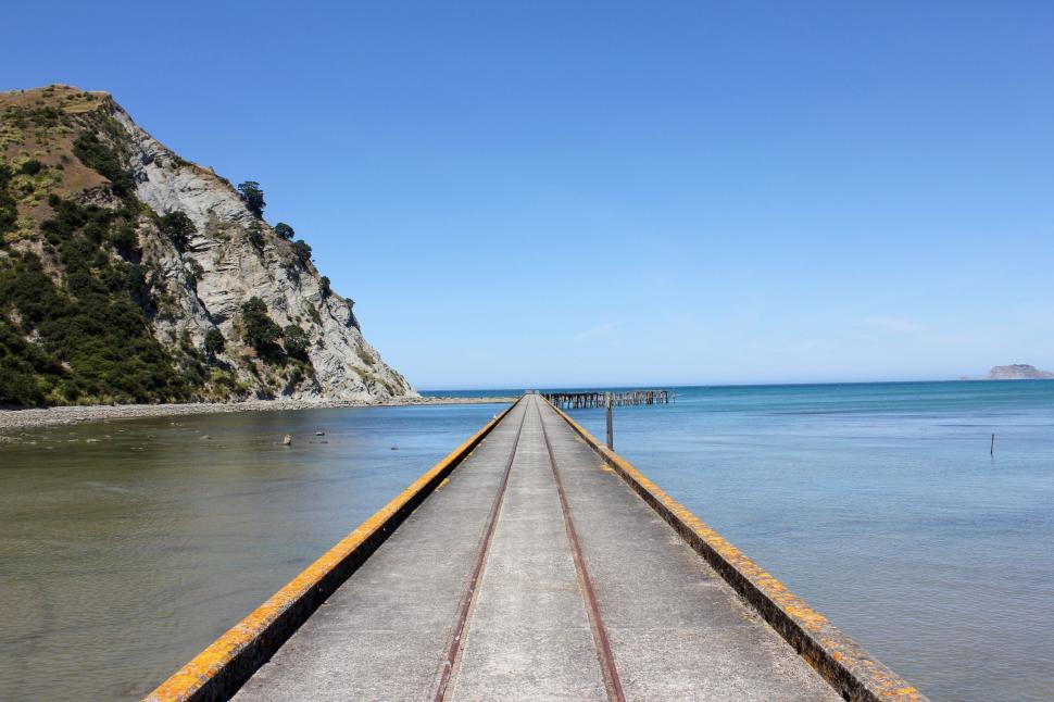 Free Image of Long Pier Extending Into the Ocean 